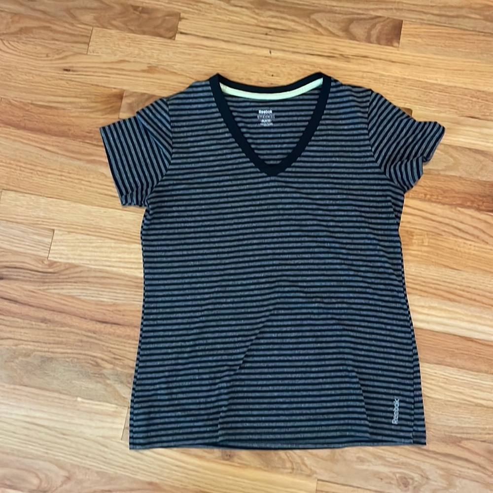 Like new black and gray striped Reebok tshirt. Women’s large